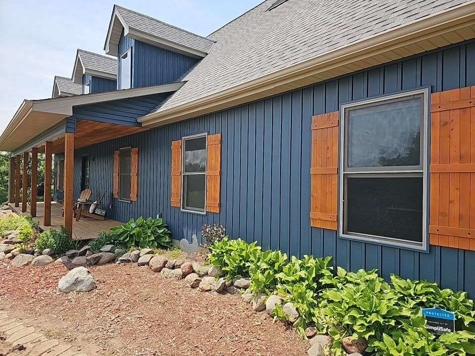 Board and batten siding with cedar shutters