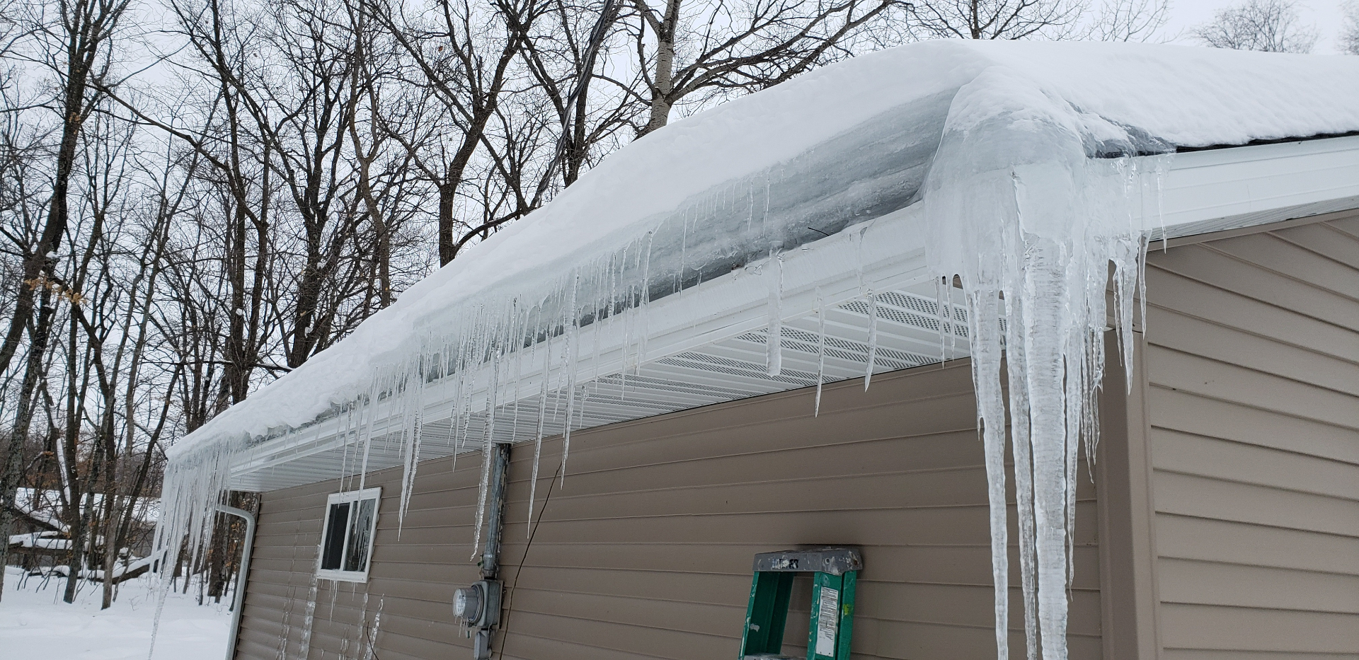 Ice dam with icicles on roof edge